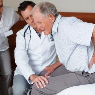 images/elderly-patient-being-assisted-by-two-doctors.jpg